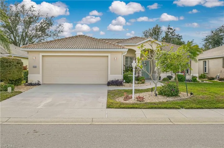 Mediterranean / spanish home featuring a front lawn and a garage