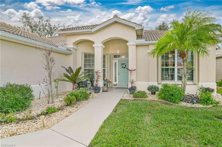 Doorway to property with a lawn