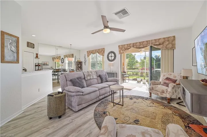 Living room with light wood-type flooring and ceiling fan