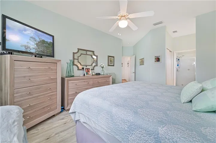 Bedroom with ceiling fan and light wood-type flooring