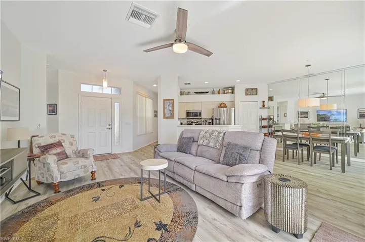 Living room with ceiling fan and light wood-type flooring