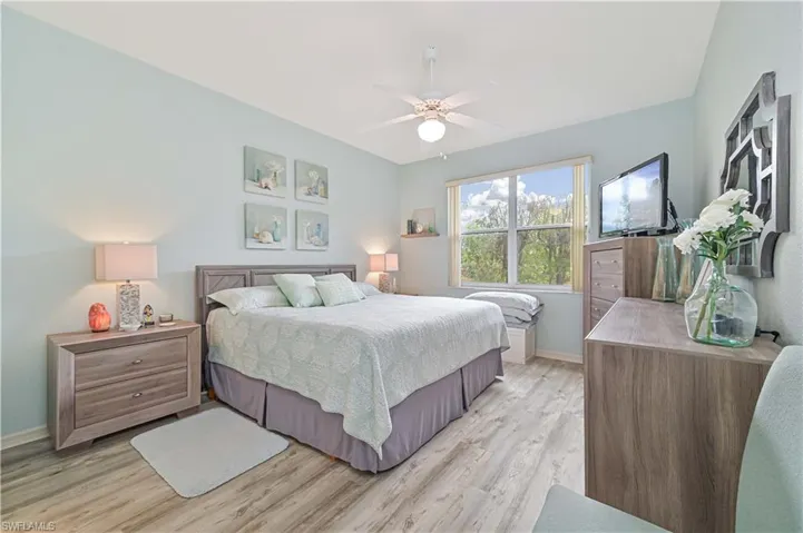Bedroom with ceiling fan and light hardwood / wood-style flooring