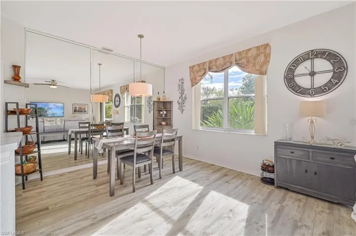 Dining area with ceiling fan and wood-type flooring