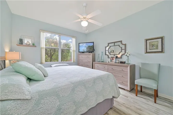 Bedroom with ceiling fan and light hardwood / wood-style flooring