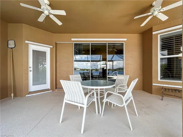 View of patio with ceiling fan and outdoor dining space