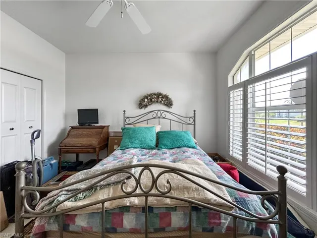 Bedroom with a closet and a ceiling fan