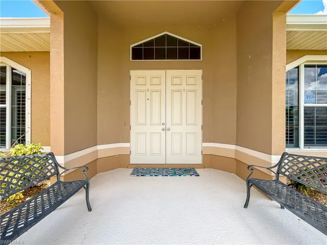 Property entrance featuring a patio and stucco siding