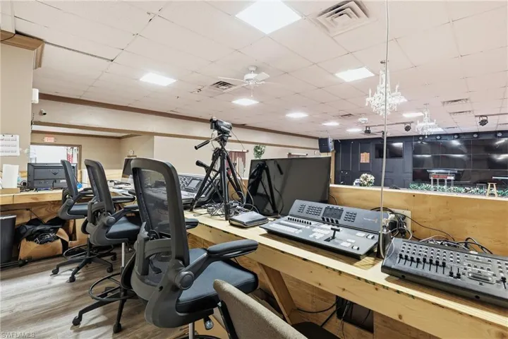 Office space with a paneled ceiling and ceiling fan