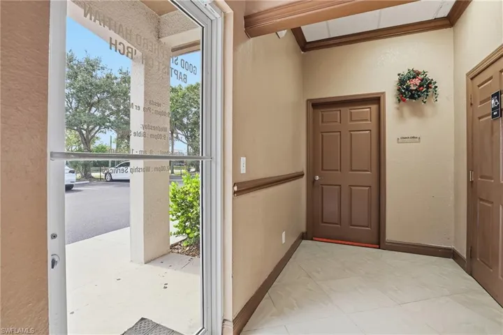 Entryway with crown molding, plenty of natural light, and tile patterned flooring