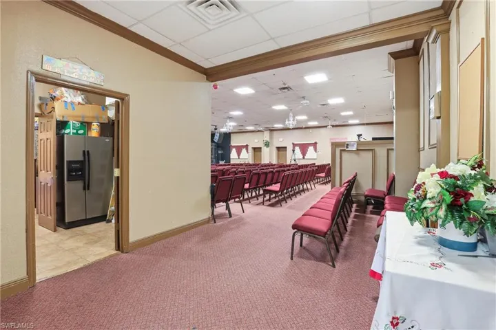 Common area with crown molding and a drop ceiling