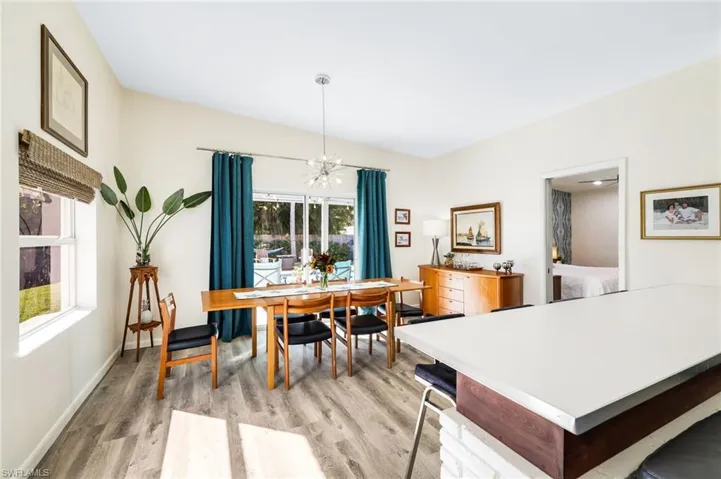 Dining space featuring light hardwood / wood-style floors and an inviting chandelier