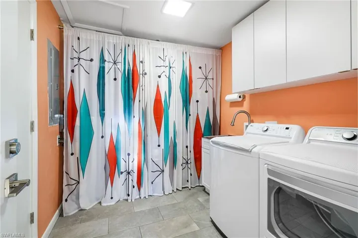 Laundry area with cabinets and independent washer and dryer