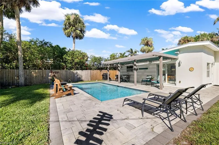 View of pool featuring a lawn and a patio