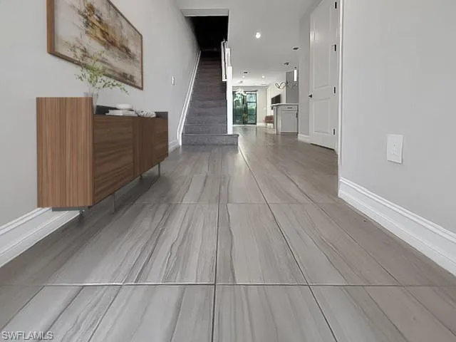 Corridor with recessed lighting and stairway