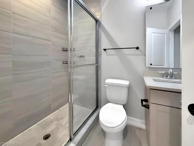 Bathroom featuring vanity and a stall shower