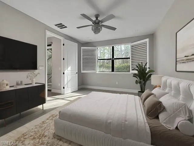 Bedroom with connected bathroom, ceiling fan, and wood finished floors