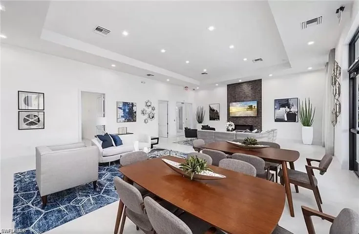 Dining area featuring a raised ceiling and recessed lighting