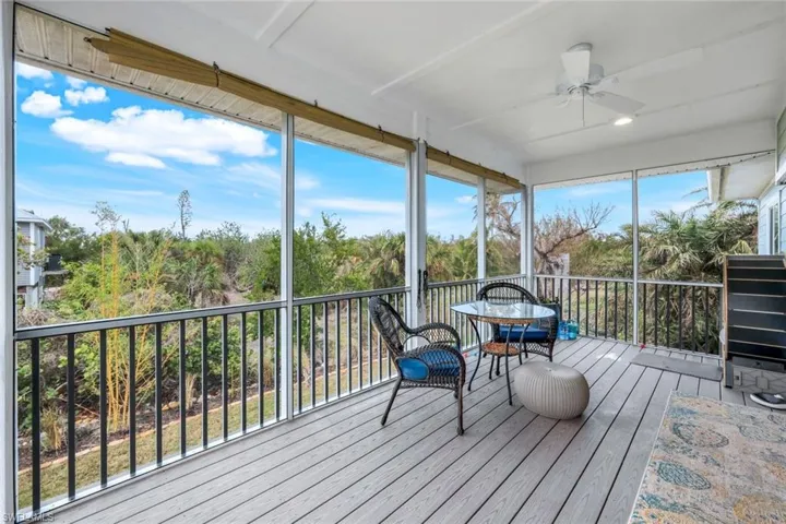 Unfurnished sunroom featuring a ceiling fan