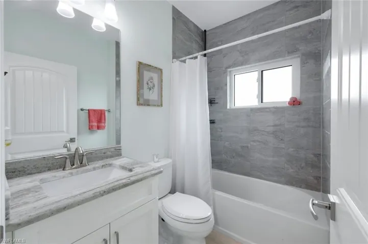 Bathroom with vanity and shower / tub combo