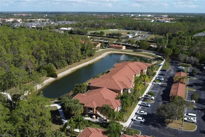 Birds eye view of property with a water view