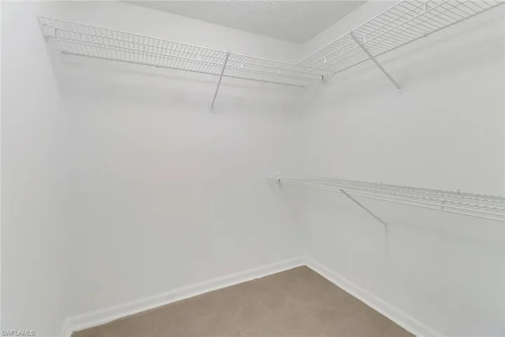 Walk in closet with tile patterned floors