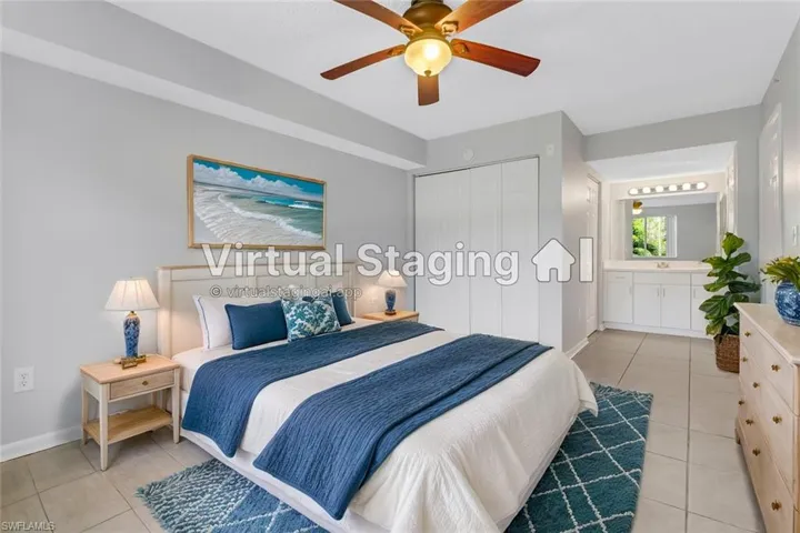 Tiled bedroom featuring ceiling fan, ensuite bath, sink, and a closet