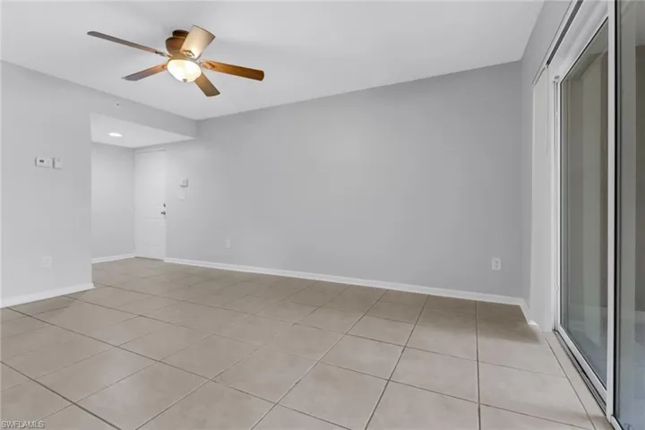 Tiled spare room with ceiling fan