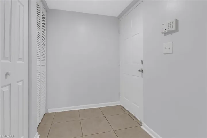 Corridor featuring light tile patterned floors