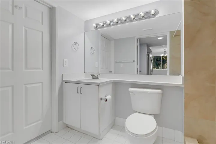 Bathroom featuring tile patterned floors, vanity, and toilet
