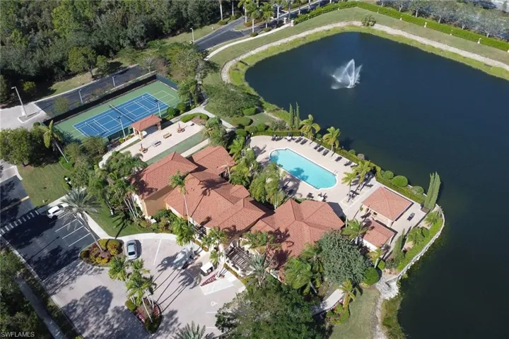 Birds eye view of property with a water view