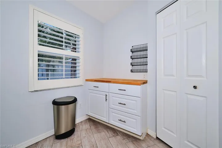 Coffee bar area with butcher block top. Pantry closet to the right.