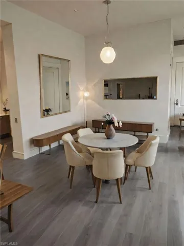 AI generated decor for the dining space of this open concept condo.