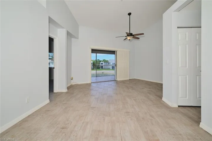 Great room with lofted ceiling, tile floors, triple sliders out to the lanai.