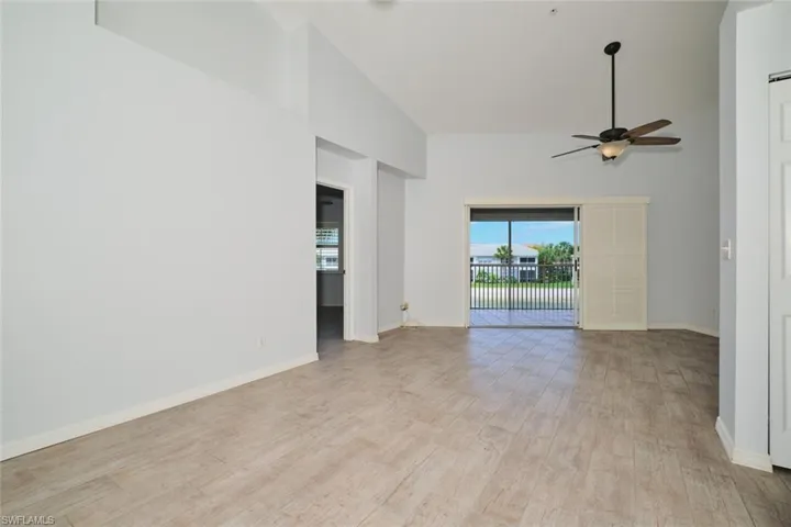 Great room with lofted ceiling, tile floors, sliders out to the lanai.