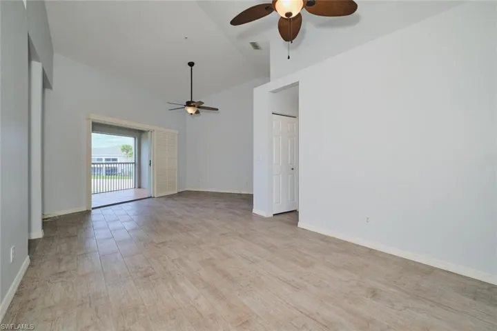 Dining and great room combo with tile floors and lighted ceiling fans.