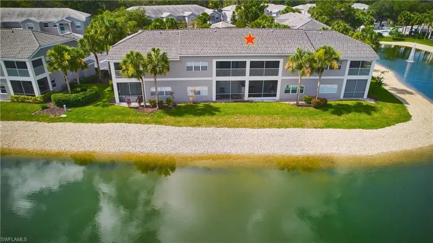 Rear view of property with a water view, stucco siding, a tile roof, and a lake view