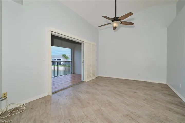 Great room with lofted ceiling, tile floors, triple sliders out to the lanai.