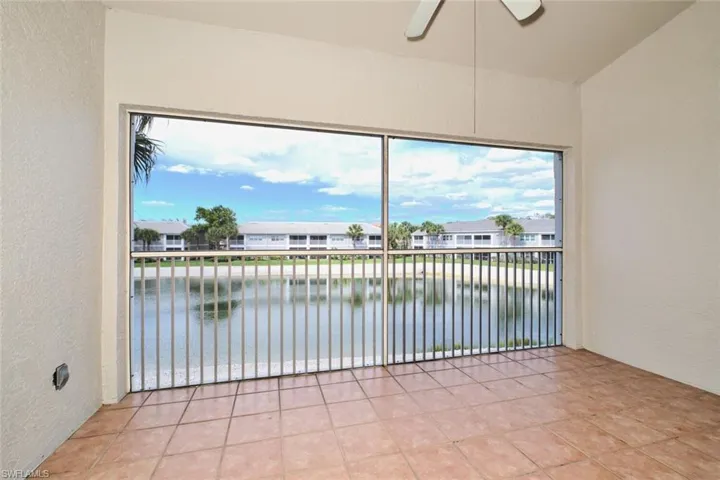 Screened lanai with tile floors and ceiling fan.