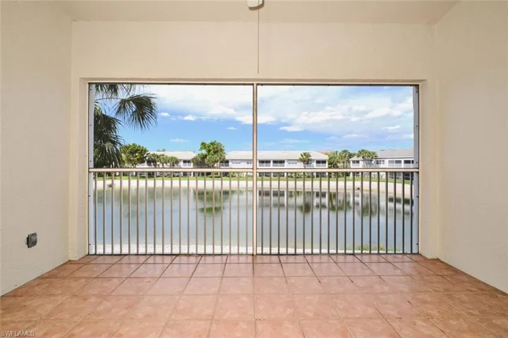 Screened lanai with tile floors and ceiling fan.
