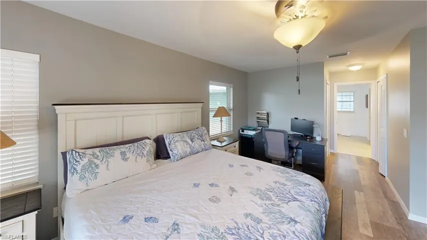 Bedroom with multiple windows and light hardwood / wood-style flooring