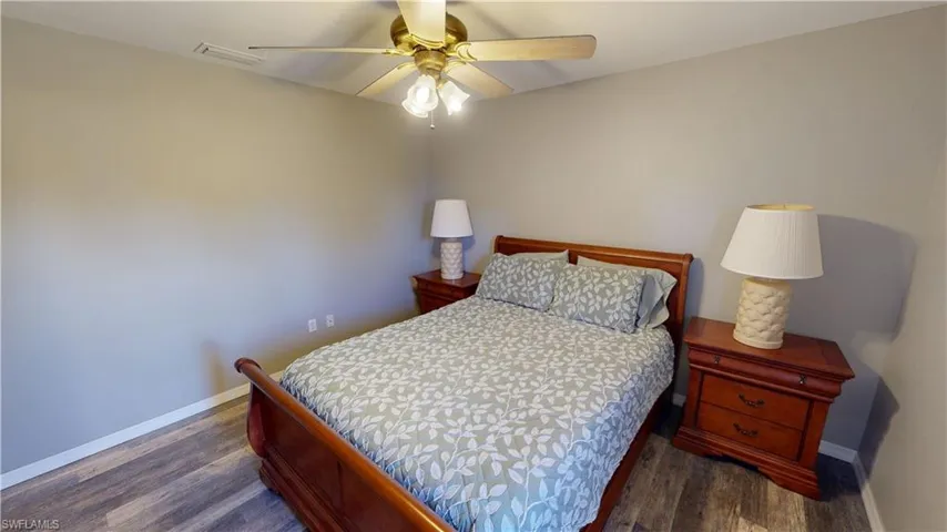 Bedroom with dark wood-type flooring and ceiling fan