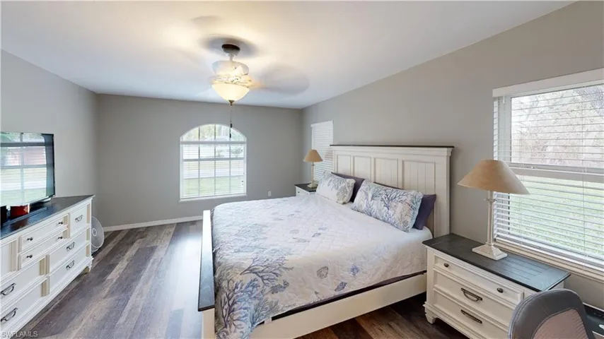 Bedroom with dark hardwood / wood-style flooring