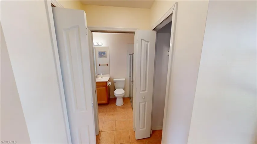 Corridor featuring light tile patterned floors