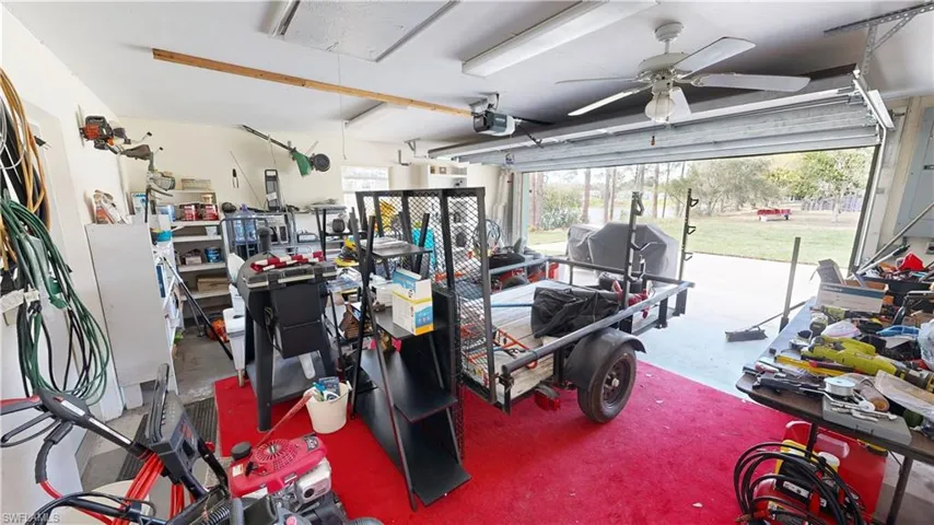 Garage featuring a garage door opener and ceiling fan