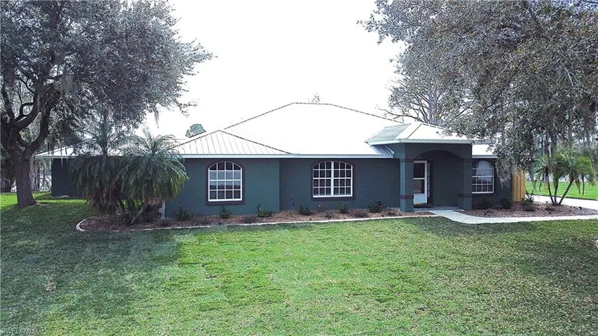 Single story home with a front lawn