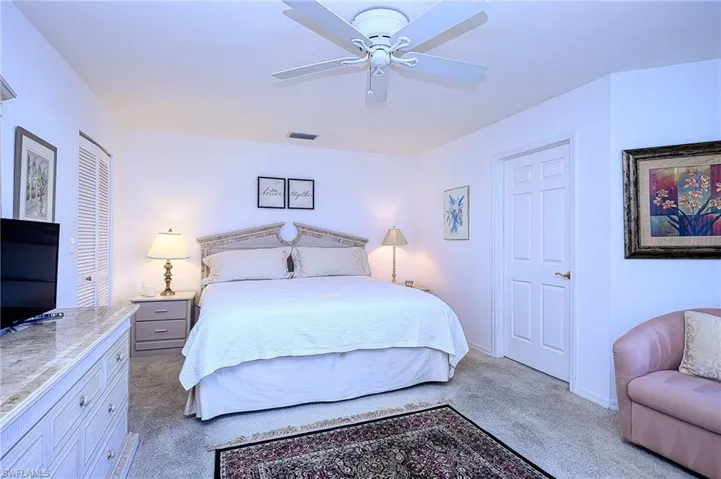 Carpeted bedroom featuring baseboards and a ceiling fan