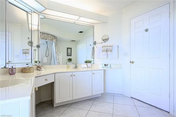 Full bath with vanity, tile patterned floors, and a shower with curtain