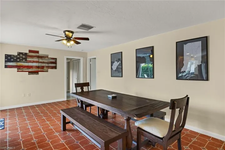 Dining area featuring a textured ceiling and ceiling fan