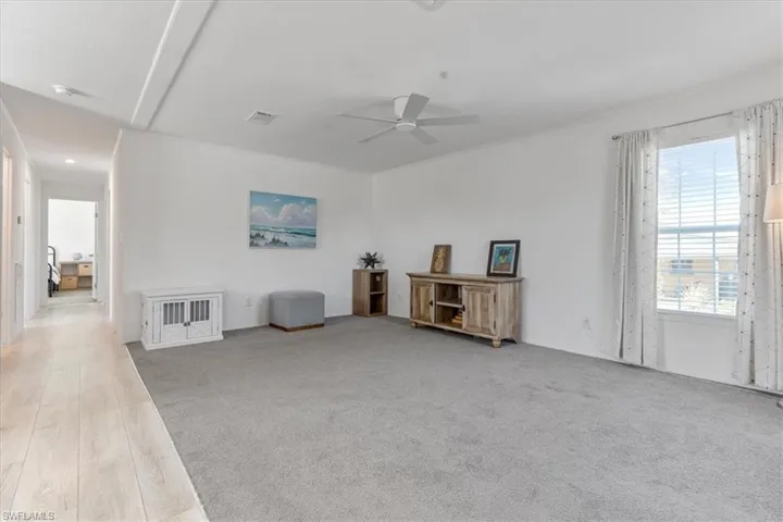 Miscellaneous room featuring ceiling fan and light hardwood / wood-style floors