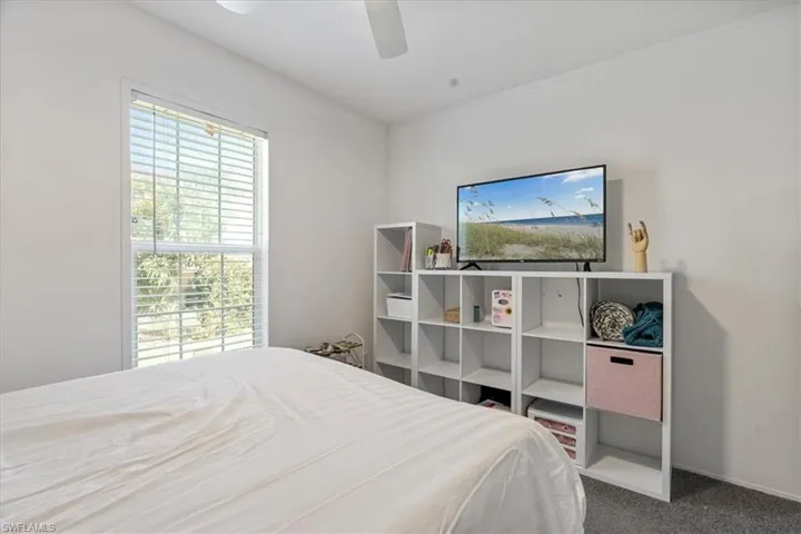 Carpeted bedroom with ceiling fan